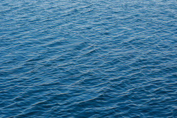 Sea surface with gentle ripples and light refracting on the surface