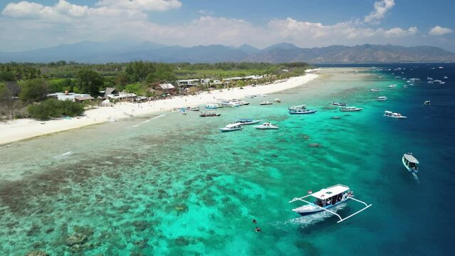 Boats floating in the coastal beach of Gili Meno.