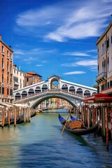 A picturesque view of a canal with a single gondola passing under an arch bridge in the heart of...