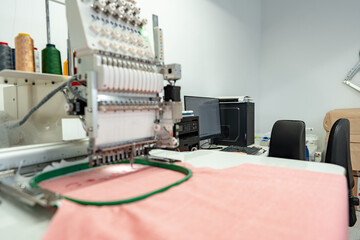 Close up of embroidery machine making patterns on textiles