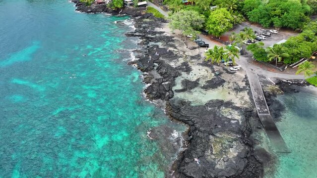Aerial ocean Two Step beach Kona Hawaii overhead 2. Beautiful cove bay with blue Pacific ocean water. Snorkel and scuba dive vacation destination. Black volcanic lava rock. Recreation and relaxation.