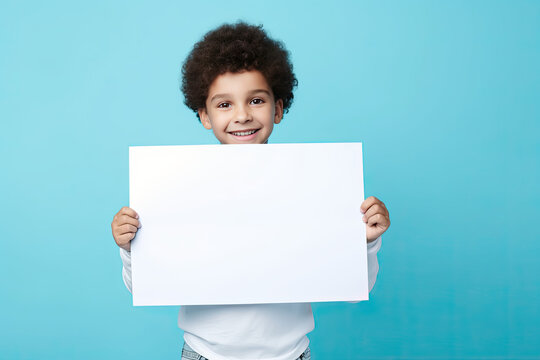 kid holding a blank placard sign poster paper in hands. empty space for editing and ads