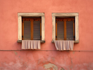 Fototapeta na wymiar two red windows on the pink wall