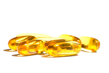 Pile of golden color oil in soft gel capsule isolated on white background. oil supplements in soft gel capsule, healthy product concept