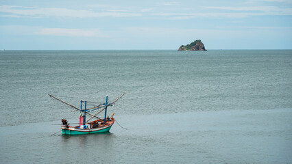 Obraz premium Small fishing boat moored in the sea