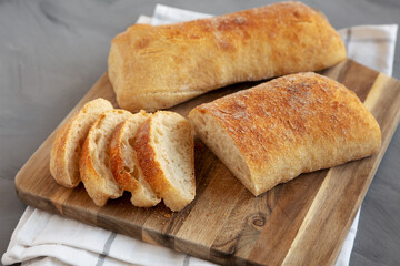 Homemade Ciabatta Bread on a wooden board, side view.