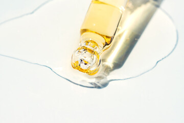 Dropper glass bottle branding mockup. Cosmetic pipette. Trendy pink background. Concept of organic...