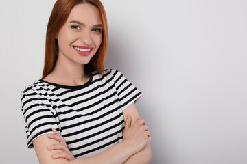 Obraz premium Portrait of beautiful young woman on light gray background, space for text