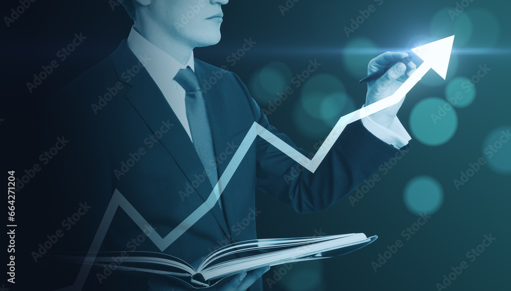 Poster close up of businessman with book pointing at creative glowing upward arrow on blurry glowing blue b