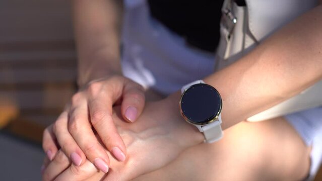 Modern sport gadget concept - young woman using a smartband 