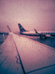 Delayed flight, raindrops on the plane window, bad weather at the airport - obrazy, fototapety, plakaty