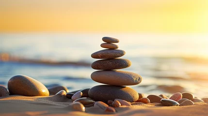 Photo sur Aluminium Pierres dans le sable Balanced rock pyramid on beach sunny day clear sky at sunset Golden sea bokeh zen stones on shore spa harmony concept