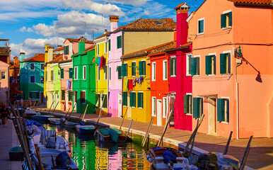 Fototapeta na wymiar Burano island in Venice, Veneto region, Italy picturesque over canal with boats among old colourful houses stone streets