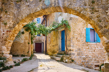 Croatia Istria. Ancient abandoned medieval town Plomin. Old stone street with ruined walls houses...