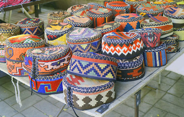 Fototapeta na wymiar Stacks of Vibrant Colored Armenian Traditional Hats Called Arakhchin for Sale at Vernissage Market in Yerevan, Armenia