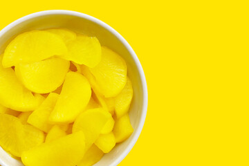 Sweet and tart slices of yellow pickled daikon, known as takuan in Japan and danmuji in Korea.