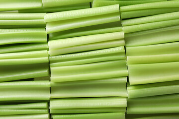 Fresh green cut celery as background, top view