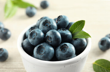 Bowl of fresh tasty blueberries on table, closeup