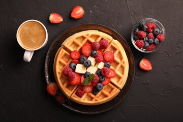 Tasty Belgian waffles with fresh berries, cheese and cup of coffee on black table, flat lay