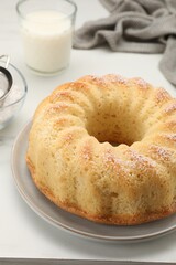 Delicious freshly baked sponge cake on white table, closeup