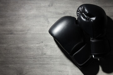 Black boxing gloves on a dark background