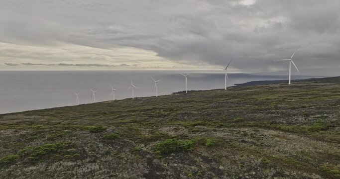 Maui Hawaii Aerial v8 flyover Auwahi wind farm with eight turbines on Ulupalakua Ranch along southeastern coastline of the island, generating renewable energy - Shot with Mavic 3 Cine - December 2022