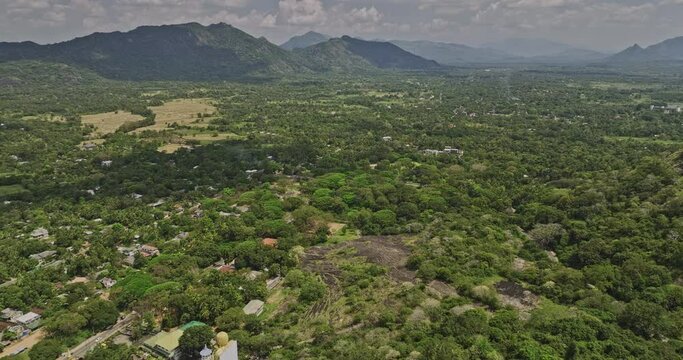 Dambulla Sri Lanka Aerial v3 drone flyover Uyanwaththa Royal Buddhist Temple capturing panoramic views of jungle landscape and mountain views from above - Shot with Mavic 3 Cine - April 2023