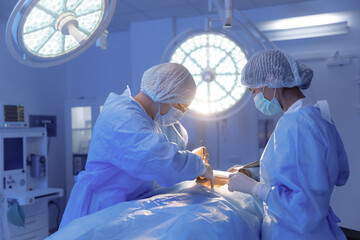 A shot of a nurse handing the surgeon a piece of equipment for the surgery he is performing in a...