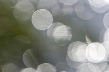 Blurry sunspots reflected in water