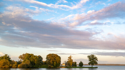 A landscape photo, view from Schwerin castle. A row of trees and beautiful sky in the sunset