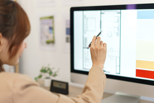 Architecture concept, Female architect checking about plan of designing house interior on computer