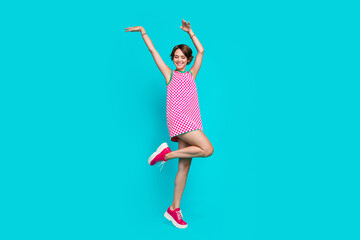 Full length photo of cheerful optimistic girl wear nice clothes preparing celebration hands up good mood isolated on cyan color background