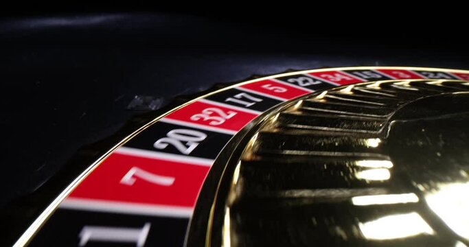 Closeup of roulette wheel gambling and nightlife. Ball spins in roulette wheel