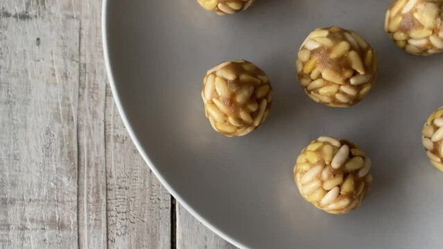 Typical snack eaten on the feast of All Saints in Catalonia. Several panellets on a wooden table. 