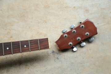 Old broken neck of guitar in long using of wood construction for fixing in shop