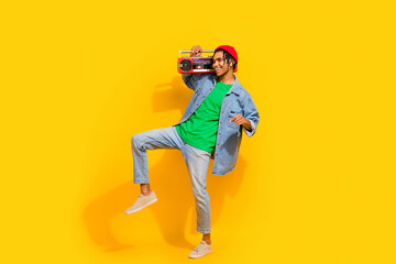 Full size photo of nice young guy dancing boom box listen music wear trendy jeans outfit isolated...