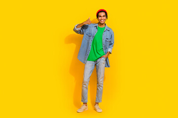 Fototapeta na wymiar Full size photo of nice young guy showing thumb up shopping banner wear trendy jeans outfit isolated on yellow color background