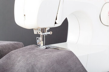 Sewing machine, stitching fabrics, needle in a round plan