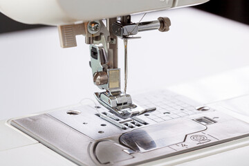 Sewing machine, stitching fabrics, needle in a round plan