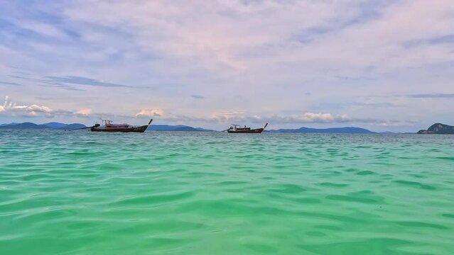 Phi Phi island off the coast of phuket thailand. Phi phi island is famous for turquoise clear blue waters teaming with Corel reef fish white soft sand and lush green trees.