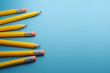 Yellow pencils on a blue background. Template Copy space for text. mockup. 3d render