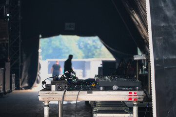 Backstage einer OpenAir Bühne mit Flycases und Kabelboxen, DJ Mischpult Mixer und Equipment.
