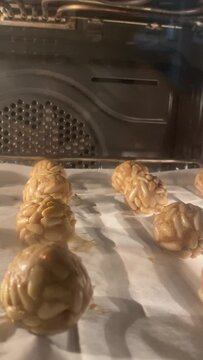 Several panellets of pine nuts browning in the oven. Typical snack eaten on the feast of All Saints in Catalonia. 