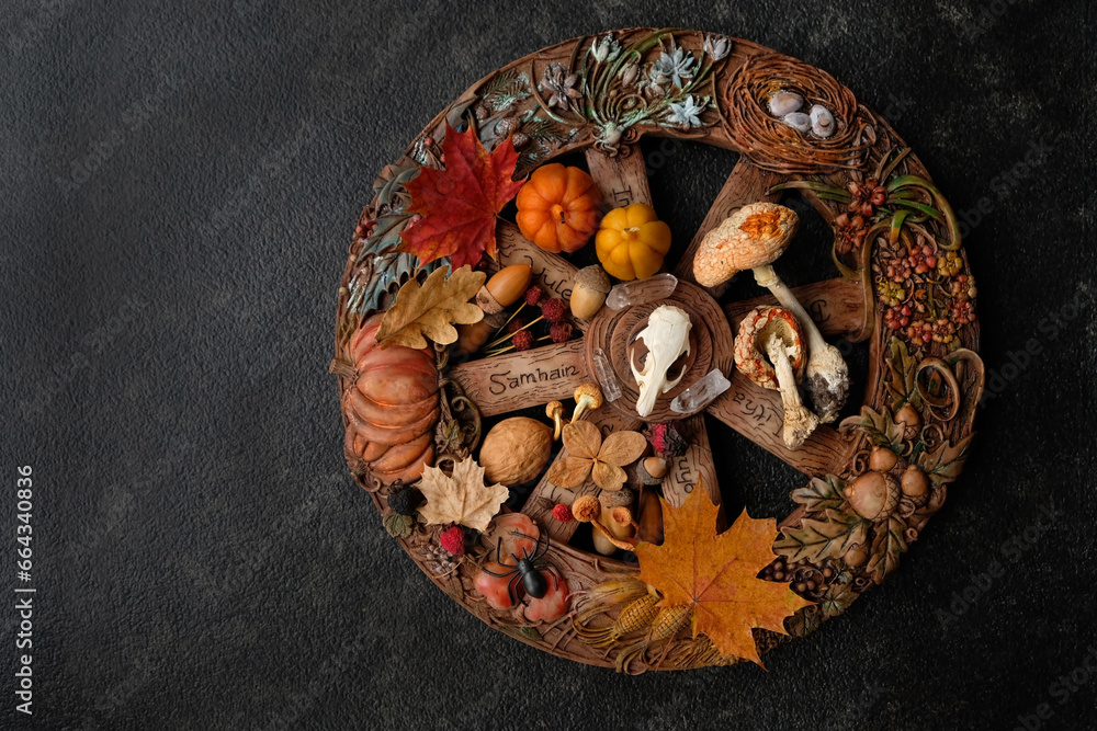 Wall mural Wiccan witch altar on dark background. wheel of the year and magic things. esoteric spiritual ritual for Samhain sabbath. Mysticism, divination, wicca, occultism, Witchcraft. flat lay. copy space