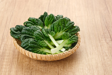 Sawi Pagoda (Tatsoi) served on rattan basket, food ingredient
