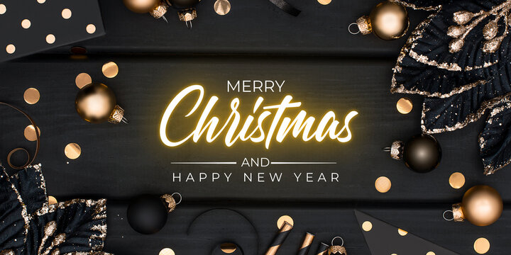 Merry Christmas and happy new year greeting  with gold ornaments, black and gold christmas frame on wooden background