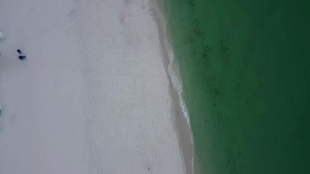 Empty beach morning walk Okaloosa Island Beach in Destin Fort Walton Beach, Florida. Aerial view of Hotels and Resorts on the beachfront of Gulf of Mexico. Doris Jordan Freeway Beachwalk morning sun