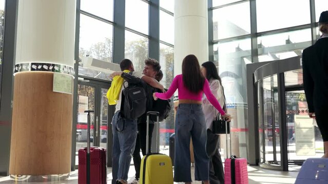 Family Meeting At The Airport. Arrival. Happy Smiling People Hugging, Cheerfully Greeting Each Other On Arrival. Crew Walking Out. Concept Of Lifestyle, Travelling, Airline, Profession, Tourism