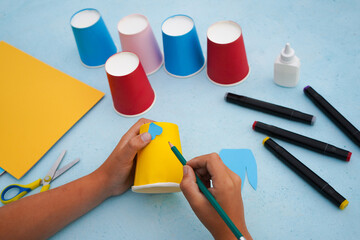 3 - Step by step diy process. Kids craft multicoloured fish from a paper coffee cup, zero waste...