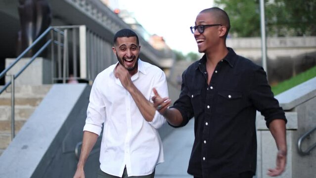 two men friends walking city enjoying and laughing having a good time together